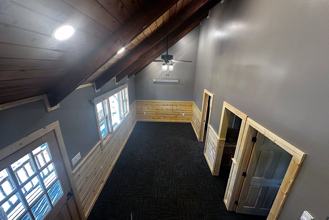 Upper level campground lodge space with vaulted ceilings, exposed timber framing, and efficient room layout showcasing mountain construction expertise by True North Construction